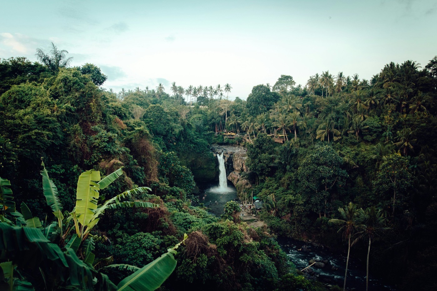 Tegenungan waterfall cascading through lush tropical jungle in Bali, Indonesia